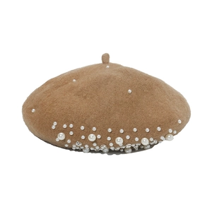 Close-up of elegant camel wool beret featuring delicate white pearls and sparkling rhinestones