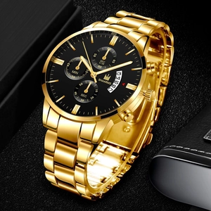Macro detail of gold stainless steel watch band and black chronograph dial with calendar
