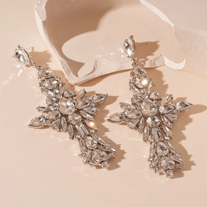 Detailed shot of Baroque cross drop earrings with sparkling rhinestones and silver pins
