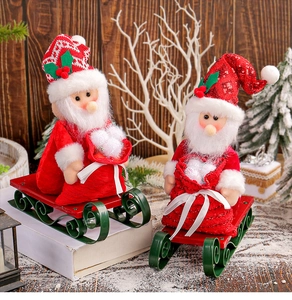 Detailed view of Christmas Santa Claus dolls with green sleds and gift bags on snow