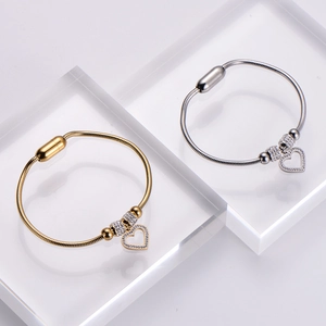 Gold and silver snake chain bracelets with hollow heart pendants and crystal accents