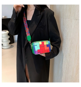 Close-up of a colorful geometric pattern crossbody bag with stylish wide woven strap