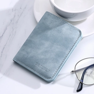 Slim light blue vertical wallet with contrast stitching on marble background