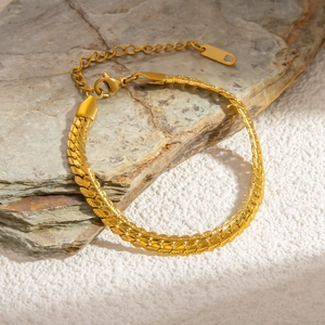 Detail of 18k gold flat snake chain with embossed texture and secure lobster clasp
