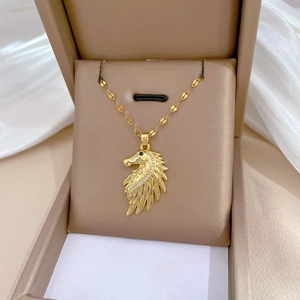 Luxurious gold horse head necklace with sparkling crystals on white silk background