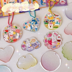 Macro shot of assorted colorful gradient DIY acrylic Goo Card shapes with ball chains