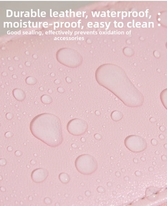 Macro shot of pink leather jewelry box showing waterproof surface and water droplets