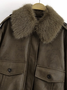 Detail of the luxurious detachable faux fur collar on a brown leather jacket for women