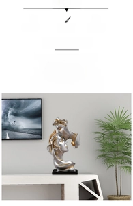 Detail of silver and gold resin couple sculpture with abstract kissing silhouettes
