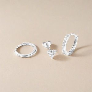 Detailed macro shot of S925 sterling silver hoop earrings set with zircon heart studs