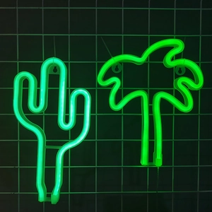 Neon LED cactus and coconut tree lights with green glow on a black wire grid background