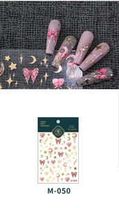 Macro detail of 3D gold butterfly and star nail art stickers with pink marble texture
