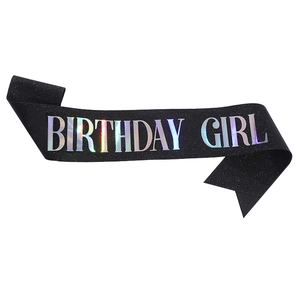 Detail of black glitter birthday girl sash with holographic iridescent lettering text