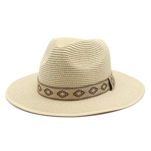Detail of beige straw Panama hat with vintage geometric pattern embroidered hatband