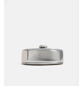 Detailed close-up of a silver polished round shoulder bag with smooth metallic finish