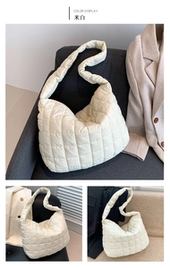 Detail of creamy white quilted puffer tote bag with soft padded nylon texture