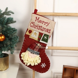 Deep red felt Christmas stocking with Santa Claus patchwork hanging on a wooden ladder