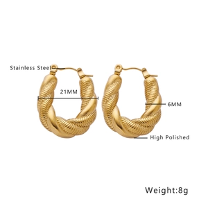 Detailed view of 21mm twisted gold stainless steel hoops with high polished woven texture