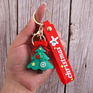 Detail of Christmas tree PVC keychain with red wrist strap and golden metal clasp