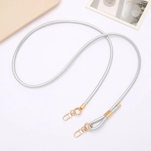 Detail of woven silver cord strap with premium gold metal swivel hooks for bags