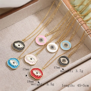 Detail view of colorful enamel evil eye necklaces showing sizes 17mm and 18mm