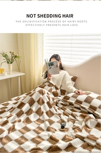 Detail of brown and white checkered plush blanket showing soft texture and no shedding