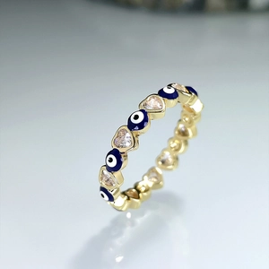 Gold open ring featuring blue enamel evil eyes and sparkling heart-shaped cubic zirconia