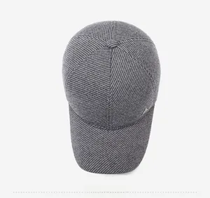 Detailed top view showing grey winter baseball cap texture and triangular metal badge