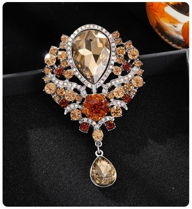 Macro detail of luxury crystal brooch with amber pendant on dark jewelry box