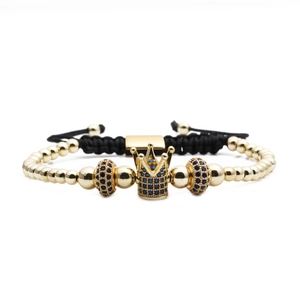 Gold and black crown charm bracelet with blue zircon beads on adjustable woven rope
