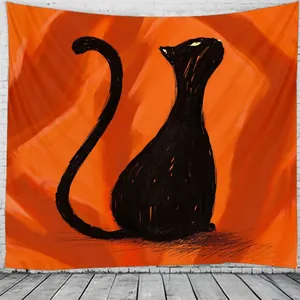 Detail of artistic black cat tapestry on white brick wall with modern orange background