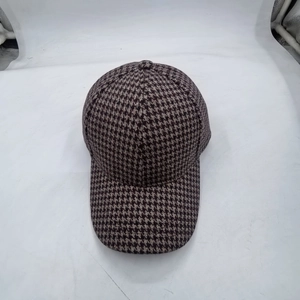 Detailed top view of a classic plaid baseball cap featuring a brown houndstooth pattern