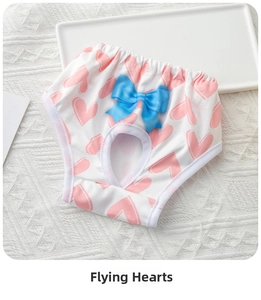 Detail of dog sanitary pants featuring pink heart patterns and a blue silk bow decoration