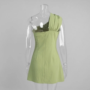 Detail view of the light green one-shoulder dress featuring hidden back zipper and texture