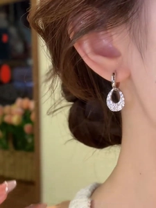 Close-up of sparkling hollow waterdrop earrings with micro-pave cubic zirconia stones