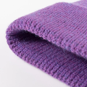 Fashionable purple knit beanie for women featuring thick ribbed wool texture for winter warmth