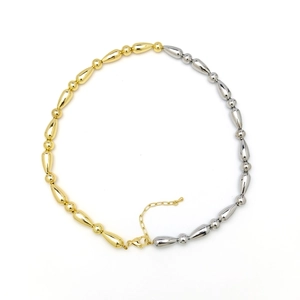 Detail of two-tone gold and silver beaded necklace with bamboo-style joints and lobster clasp