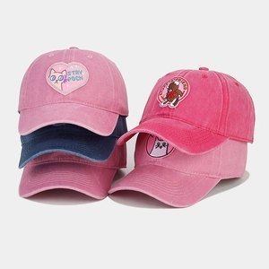 Detailed close-up showing washed cotton texture and cute animal embroidery on caps