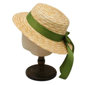 Women's flat top straw boater hat with wide brim and green satin ribbon bow for beach sun protection