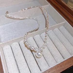 Elegant silver necklace with zircon and large pearl pendant displayed in a jewelry box