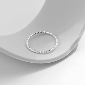 Minimalist S925 sterling silver ring with textured diamond-cut finish in a macro view
