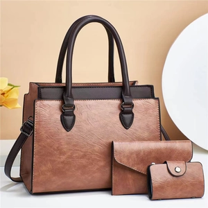 Brown faux leather three-piece handbag set featuring tote bag and envelope clutch bags