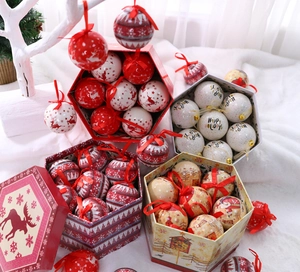 Detailed view of four sets of festive Christmas ball ornaments with hanging strings
