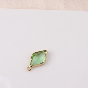 Detail of green rhombus crystal pendant with gold plating for DIY jewelry making