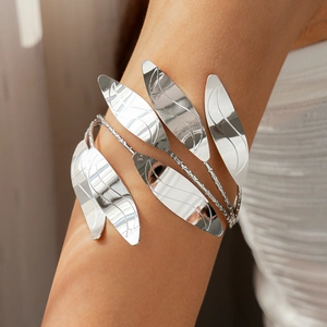 Detail of silver multi-layer leaf arm cuff featuring intricate leaf vein texture and shine