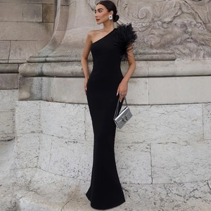 Detailed view of elegant black one-shoulder evening gown with premium feather trim accents
