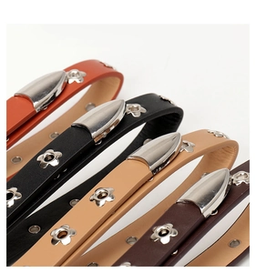 Detail view of four leather bracelets with flower shaped metal studs in multiple colors