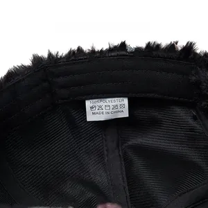 Close-up of internal washing label showing 100% polyester material and fabric texture