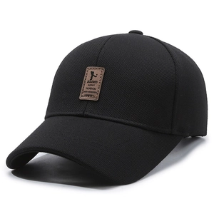 Classic black textured fabric baseball cap with a vintage leather sport patch on front