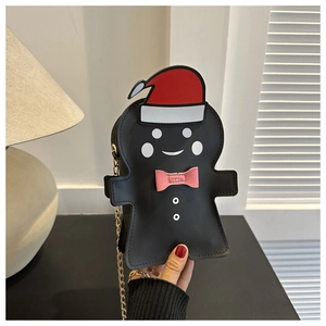 Detail view of gingerbread man crossbody bag with red hat and gold chain strap